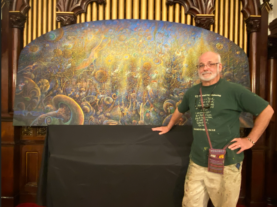 Artist Daniel Hauben posing in front of Emergence